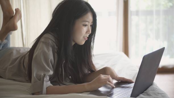 istock Young women use laptops to work at home. 1285884393