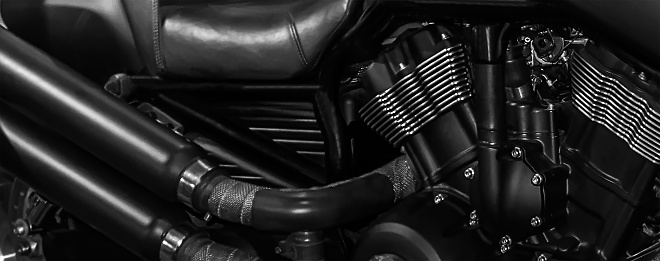 Motorcycle Engine with exhaust pipes on a dark background soft focus