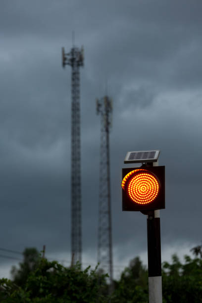 istock Traffic light with solar cell panel on the top against stormy cloud. 1285885399