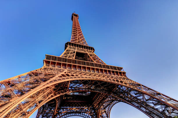 istock Architectural details of the Eiffel Tower at sunrise against a clear blue sky 1285885949