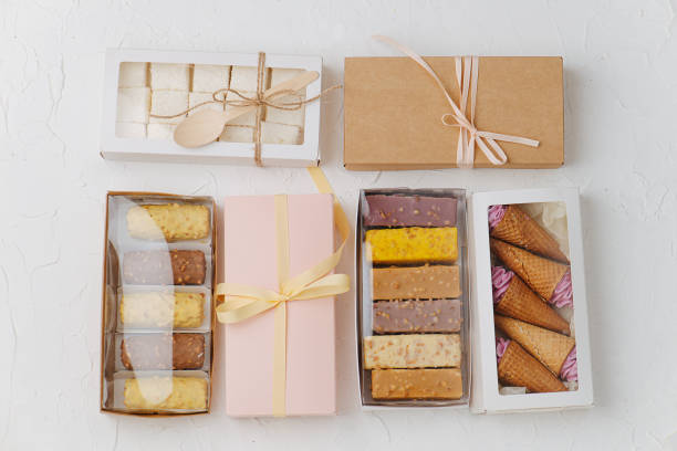istock Variety of sweets in windowed and sealed boxes. Top view. On white surface. 1285886113