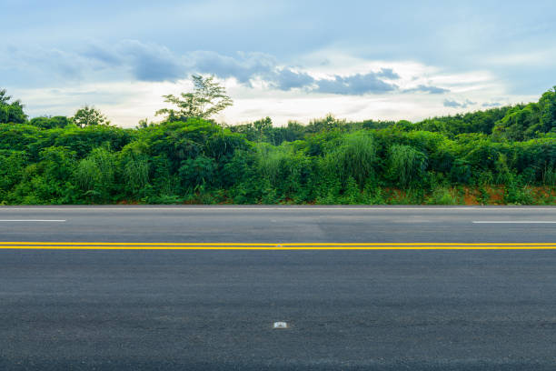 istock Side view of asphalt road with dark sky background 1285888819