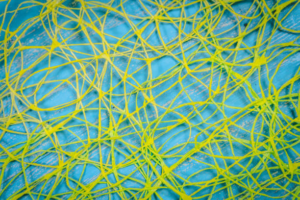 istock Abstract background of yellow threads on blue background 1285889747