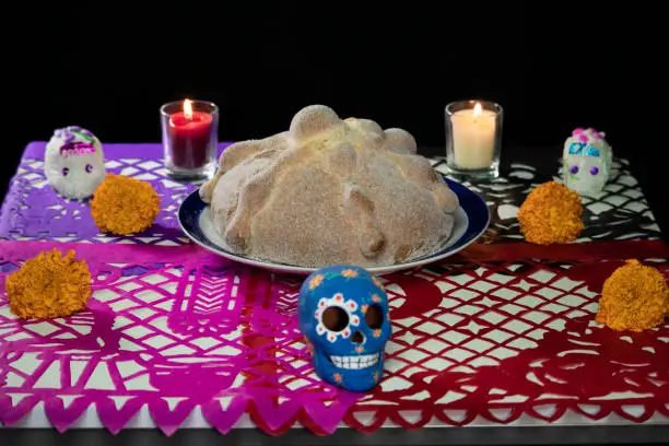 A very traditional Mexican offering with pan de muerto and skulls