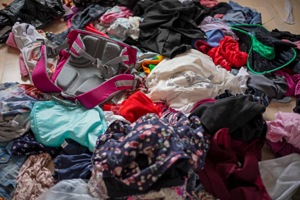 istock scattered children's clothes and rucksack in the room, clutter, horizontal, blurred, 1285893338