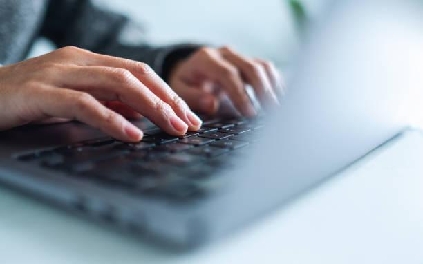 istock a woman working and typing on laptop computer keyboard on the table 1285894043