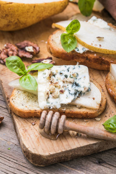 istock Toast or canape  with goat cheese, basil, honey, nuts.  Delicious appetizer, ideal as an aperitif. 1285895003