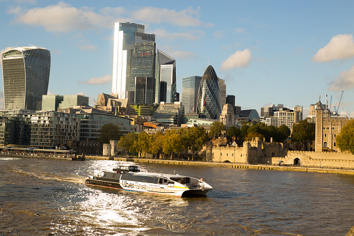 River Thames, London, 2020.  River Thames with an UBER boat which takes tourists and workers up the river - this is the only boat service currently running due to coronavirus and is virtually empty