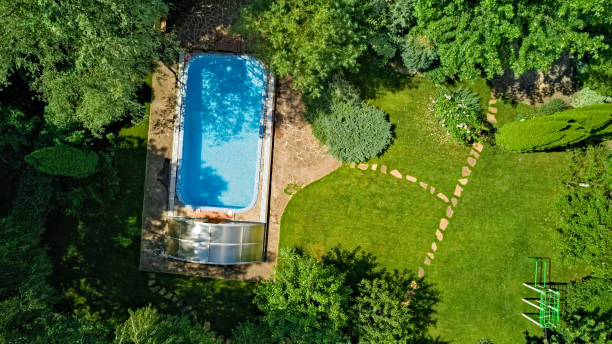 istock Swimming pool in beautiful garden aerial top view 1285896231
