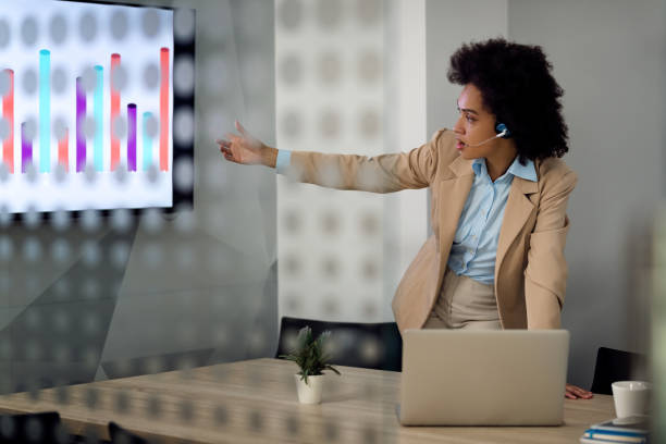 istock Black entrepreneur explaining business graph during conference call in the office. 1285896507