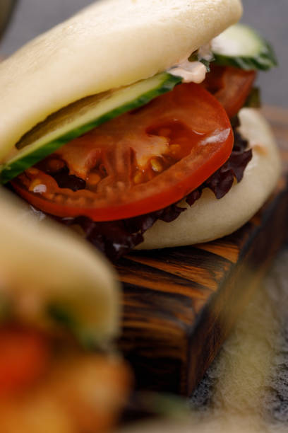 Steamed wheat bun dressed with designer sauce. Vietnamese cuisine concept. Still life. Close-up.