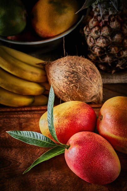 istock Group of ripe tropical fruits on a table in a rustic kitchen 1285898516