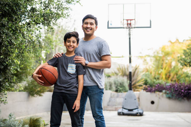 istock Father and son standing outside with a basketball 1285898819