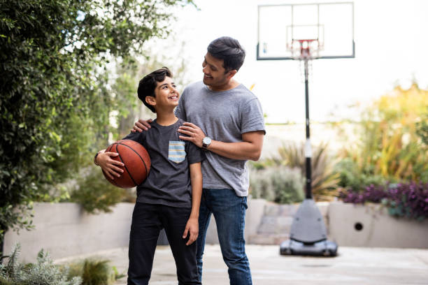 istock Father and son standing outside with a basketball 1285898826