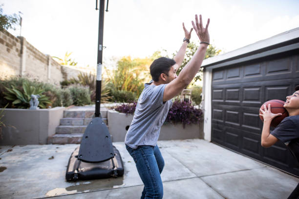 istock Hispanic father and son playing basketball in the backyard 1285898834