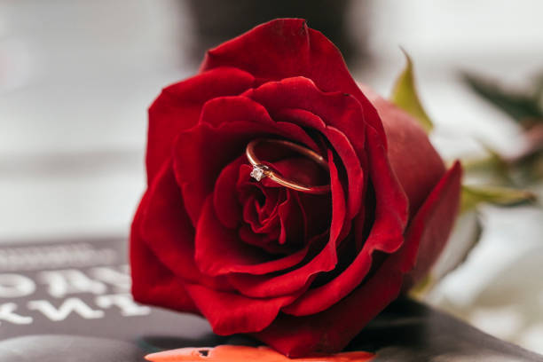istock red rose and wedding ring in a red box close up 1285899931