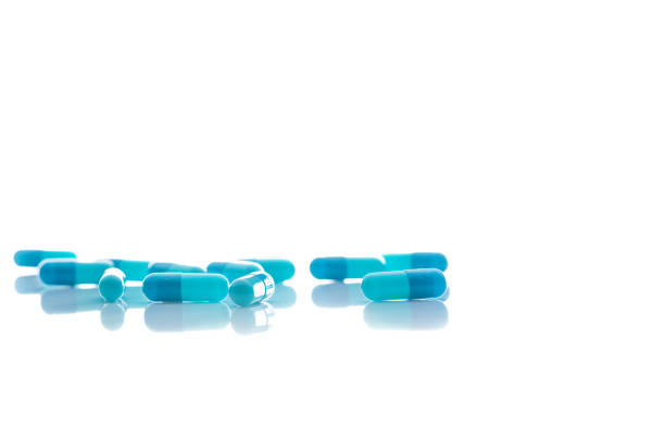 istock Selective focus on blue capsule pill on white background. Pharmaceutical industry. Pharmacy or drugstore products. Healthcare and medicine. Health budget. Pharmaceutical manufacturing. Pharmaceutics. 1285900495