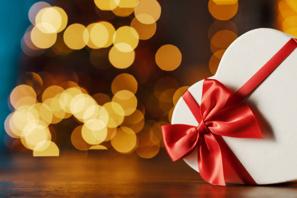 istock Heart shaped Christmas present and decorative lights 1285901753