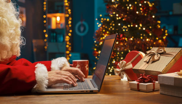 istock Santa Claus connecting online at Christmas 1285902625