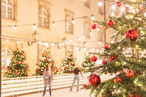 istock Christmas tree with red balls on the ice rink, blurred background 1285902821