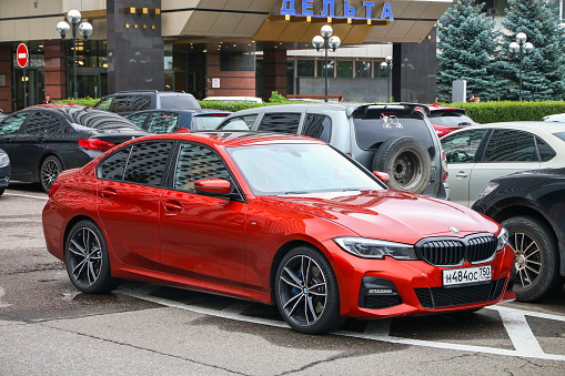 Moscow, Russia - August 13, 2020: Red compact sedan BMW 3-series (G20) in the city street.