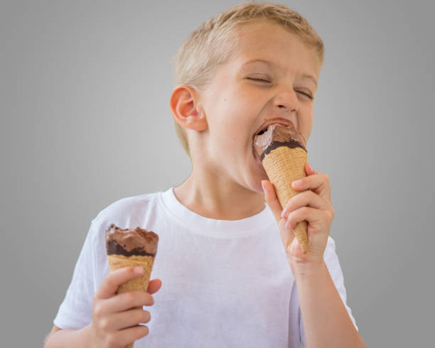 istock beautiful child boy eats ice cream on a stick 1285903083