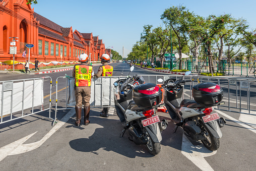 Bangkok, Thailand - December 7, 2019: Police with motorcycle resguard tourist area near The Grand Palace in Bangkok, Thailand.