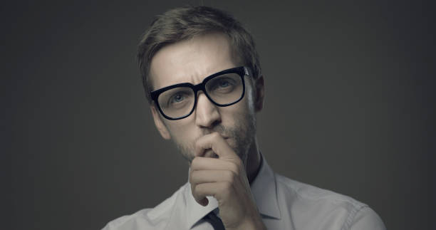 istock Pensive man thinking with hand on chin 1285905432