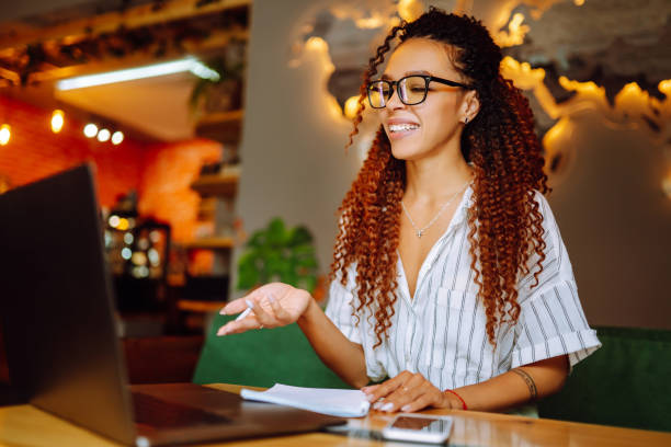 istock Young woman wear wireless headphone study online, watch webinar, online briefing,  distant education, conference with coworkers. 1285905509
