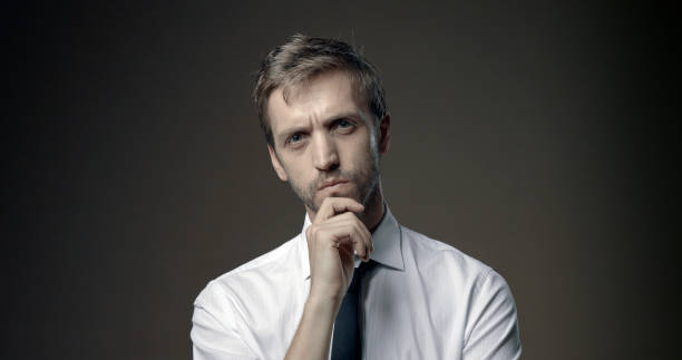 istock Pensive man thinking with hand on chin 1285905650