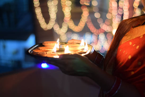 COLLECTION OF DIYA PLATE  LIGHT IN HAND WITH BOKEH
