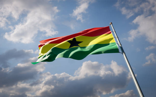 istock Ghana national flag waving at sky background close-up. 1285907012