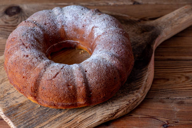 istock Round cake with a hole inside on a wooden board. Blur and selective focus 1285908014