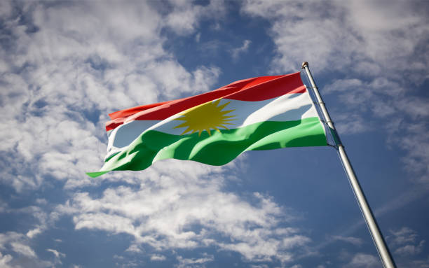 istock Kurdistan national flag waving at sky background close-up. 1285908020