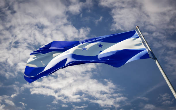 istock Honduras national flag waving at sky background close-up. 1285908028