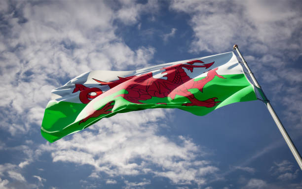 istock Wales national flag waving at sky background close-up. 1285908059