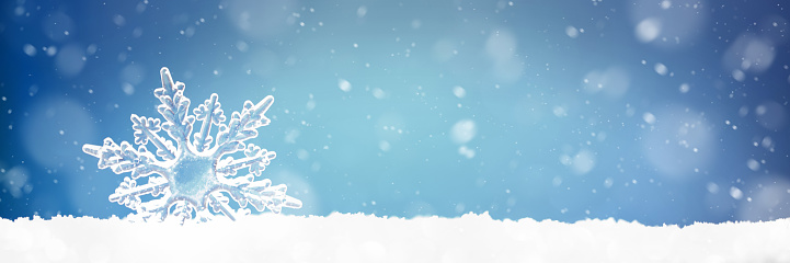 Christmas background with a decorative snowflake on brilliant snow, copy space