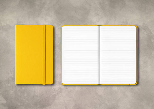 istock Yellow closed and open lined notebooks on concrete background 1285911107