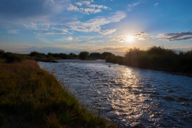 istock Beautiful sunset above the river with orange clouds. Cloudy sky sunset view. Gold background. Twilight sky background. 1285911707