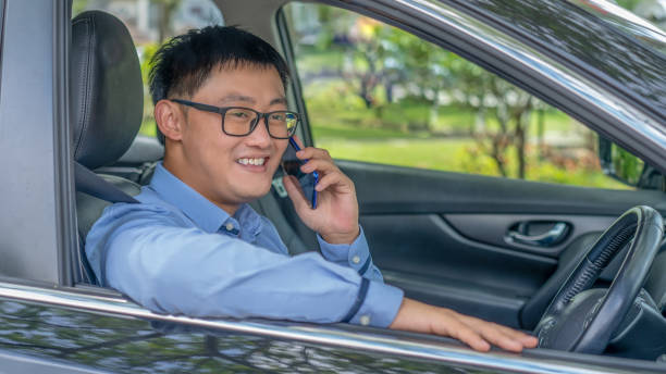 istock Happy young business man in car using smart phone 1285913206