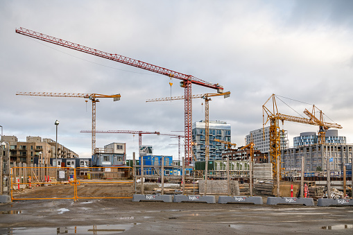 Copenhagen Harbor, Copenhagen, Denmark, November 7, 2020. Construction site with cranes in a part of the harbor which is being converted to a residence district