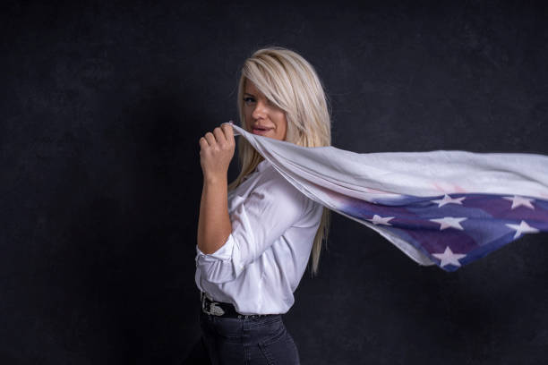 istock Woman is holding american flag 1285913496