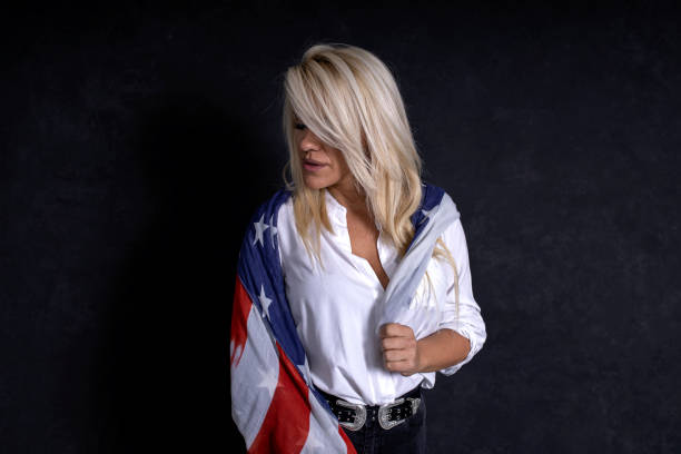 istock Woman draped american flag 1285913497