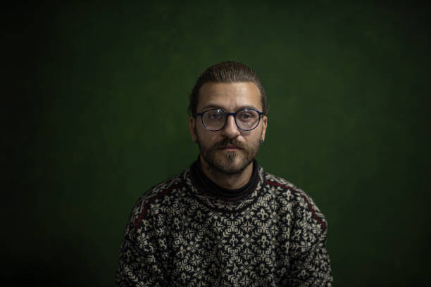 istock Portrait of man in dark background 1285913657