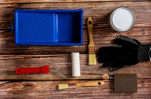 istock Set of tools for painting on wooden table background top view 1285915971