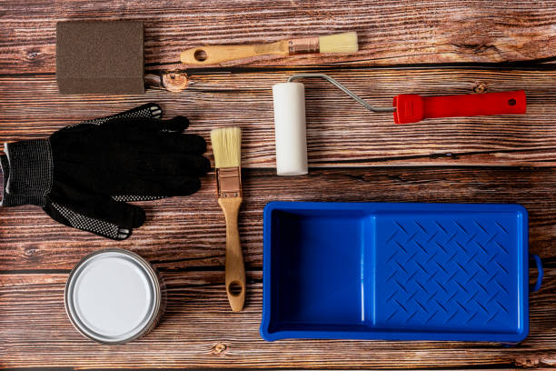 istock Set of tools for painting on wooden table background top view 1285916046