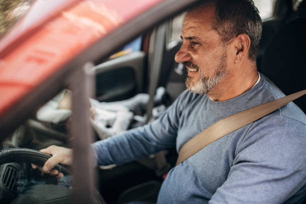 istock Smiling grandfather driver with grandson 1285916249