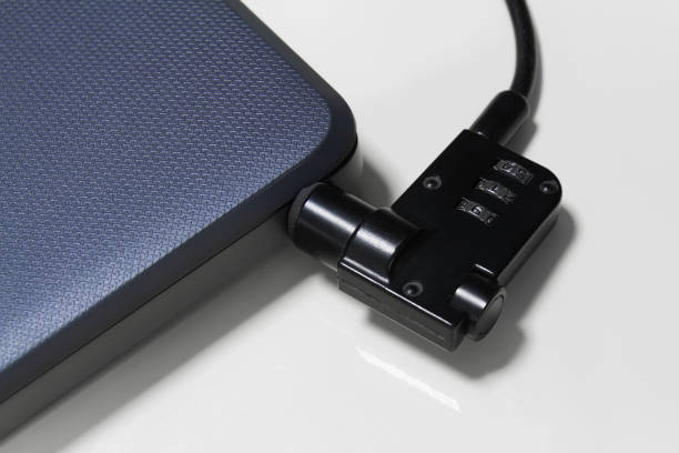 istock Laptop with a combination lock in the store. Closeup, selective focus 1285916740