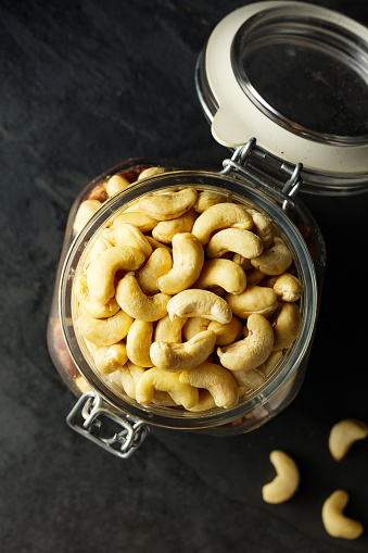top view of cashew in the jar against slate background