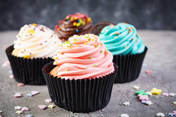 istock Tasty colorful cupcakes isolated on grey background. Delicious cupcake 1285918908